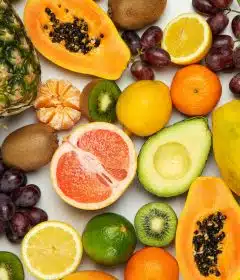 sliced orange fruit and green round fruits
