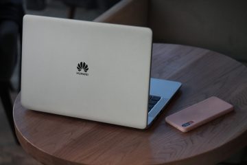 silver macbook on brown wooden table