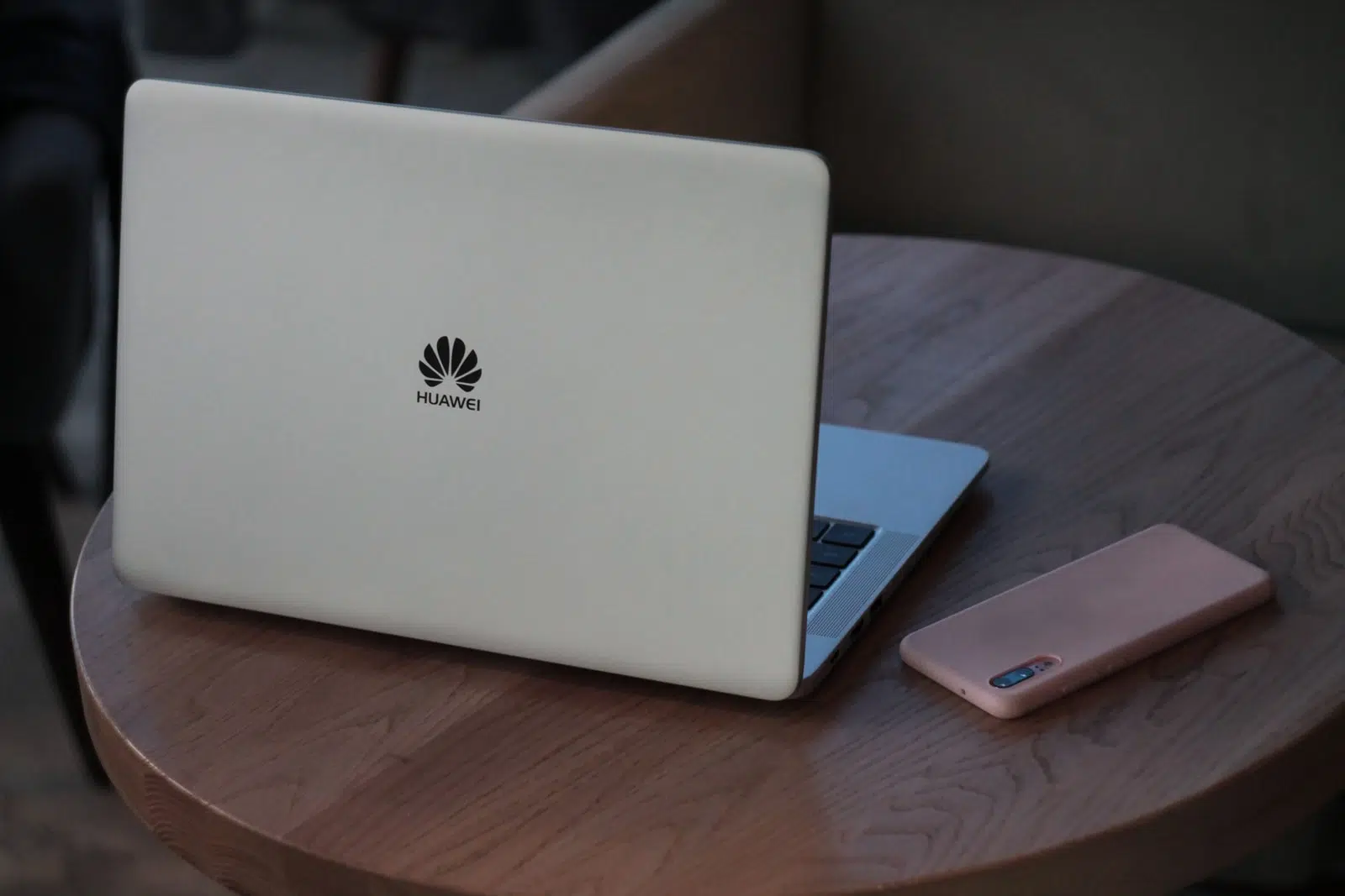 silver macbook on brown wooden table